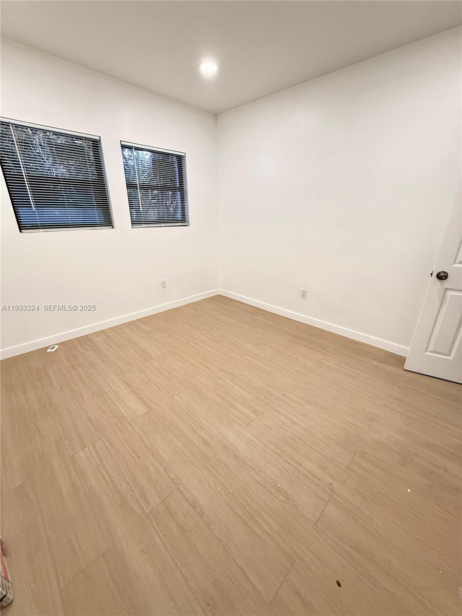 125 Southwest 19th Avenue, Unit 2 Miami, FL 33135 - Photo 5 of 8 an empty room with windows