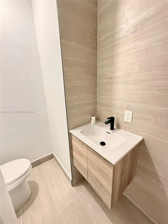 a bathroom with a sink a toilet and mirror