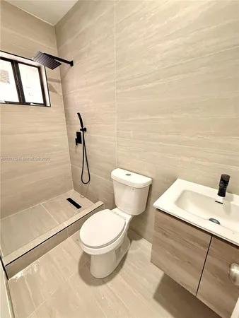 a white toilet sitting next to a bathroom sink