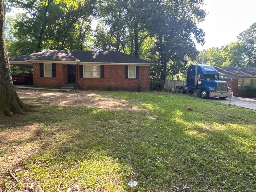 5369 Lochinvar Road Memphis, TN 38116 - Photo 1 of 11 a backyard of a house with yard and tree