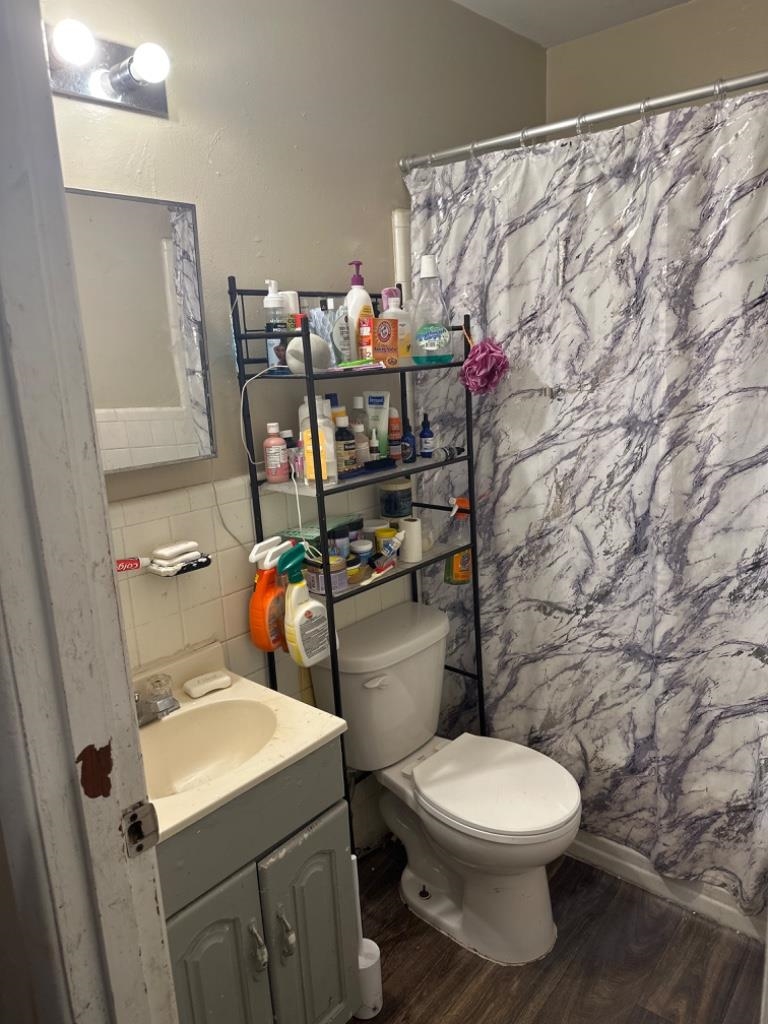 5369 Lochinvar Road Memphis, TN 38116 - Photo 4 of 11 a bathroom with a toilet and a shower curtain