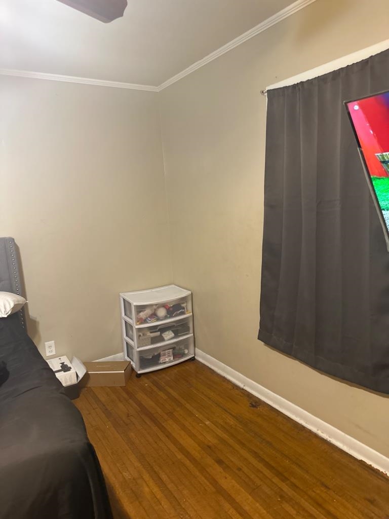 5369 Lochinvar Road Memphis, TN 38116 - Photo 6 of 11 a room with a bed and a wooden floor