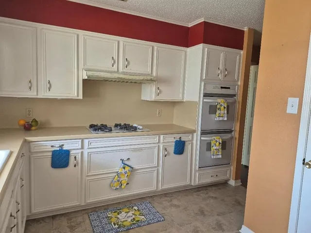 a kitchen with stainless steel appliances granite countertop a refrigerator and sink