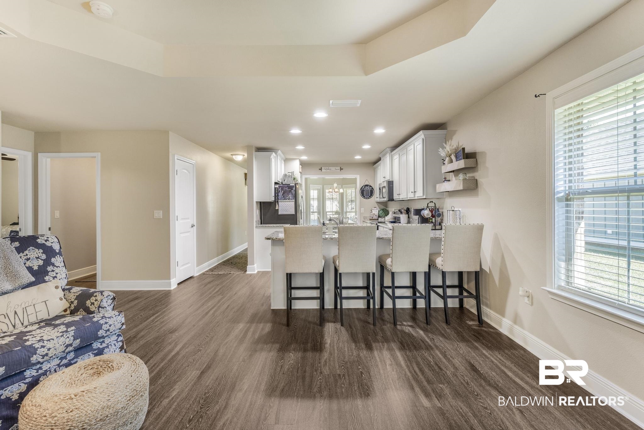22043 Garland Loop Silverhill, AL 36576 - Photo 17 of 41 Kitchen featuring white cabinets, recessed lighting, a kitchen bar, a peninsula, and dark wood-style flooring