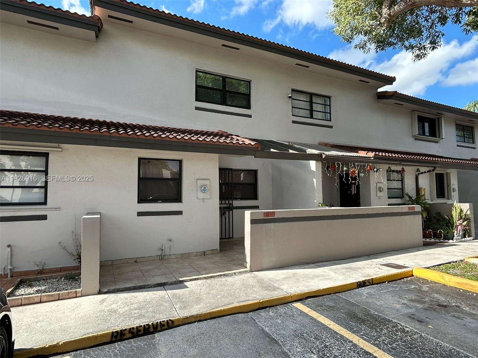 13444 Southwest 62nd Street, Unit 104F Miami, FL 33183 - Photo 1 of 40 a view of a house with a patio