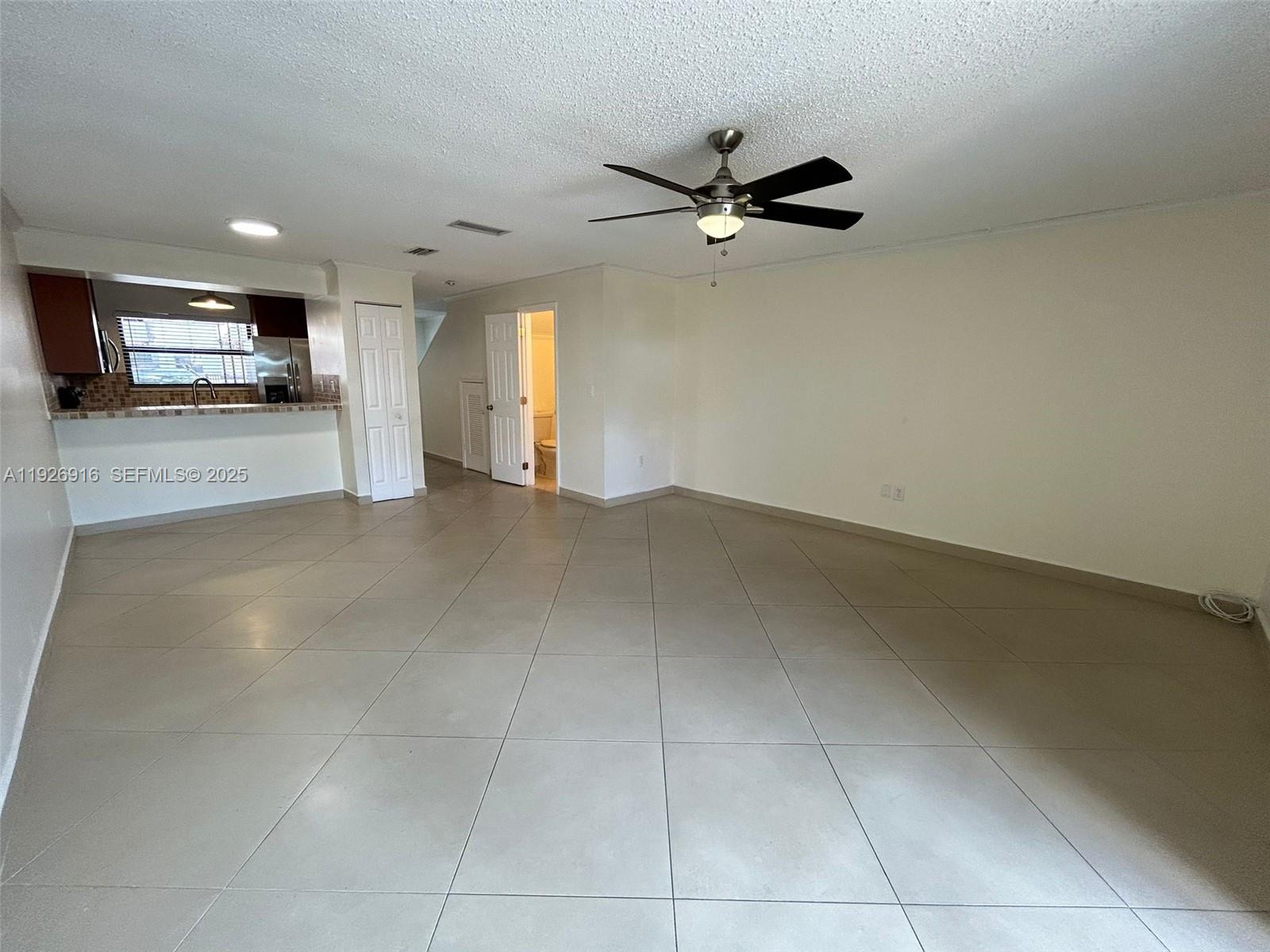 13444 Southwest 62nd Street, Unit 104F Miami, FL 33183 - Photo 15 of 40 a view of a livingroom with a ceiling fan and window
