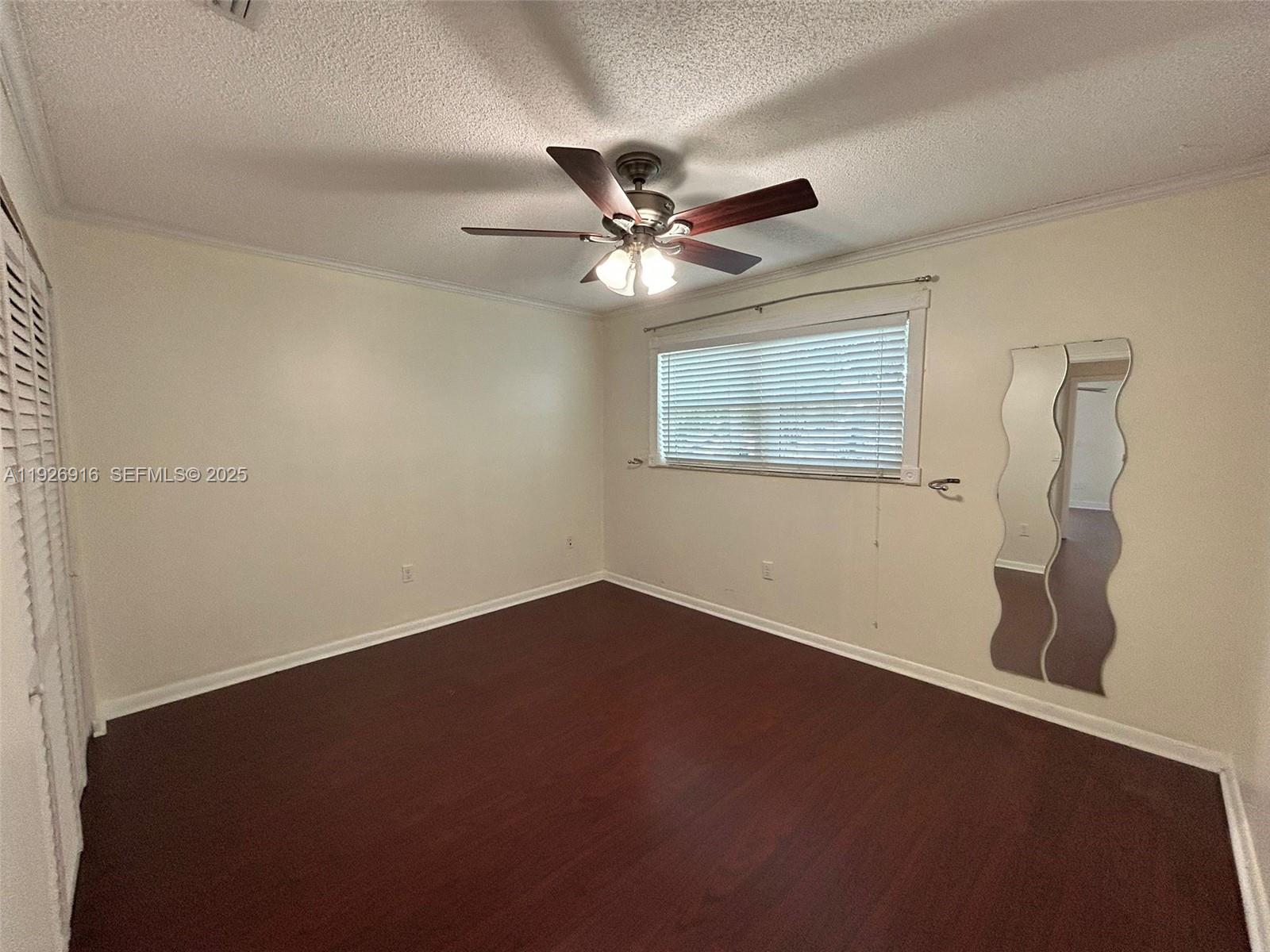 13444 Southwest 62nd Street, Unit 104F Miami, FL 33183 - Photo 20 of 40 an empty room with a window and a fan