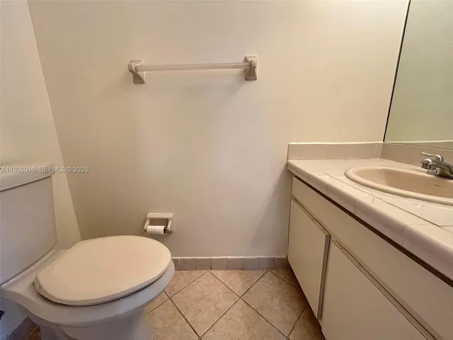 a white toilet sitting next to a shower