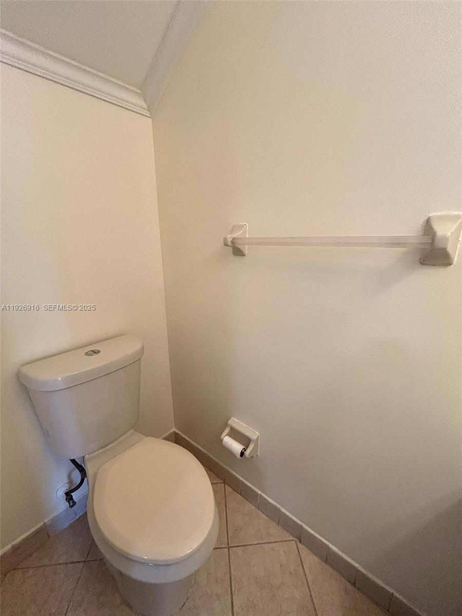 13444 Southwest 62nd Street, Unit 104F Miami, FL 33183 - Photo 23 of 40 a white toilet sitting next to a shower
