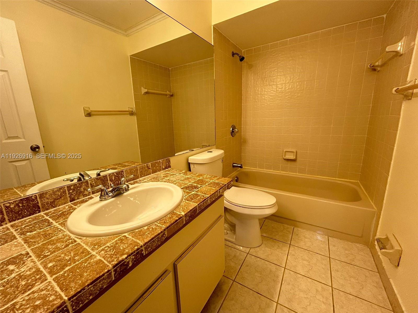 13444 Southwest 62nd Street, Unit 104F Miami, FL 33183 - Photo 28 of 40 a bathroom with a sink toilet and shower