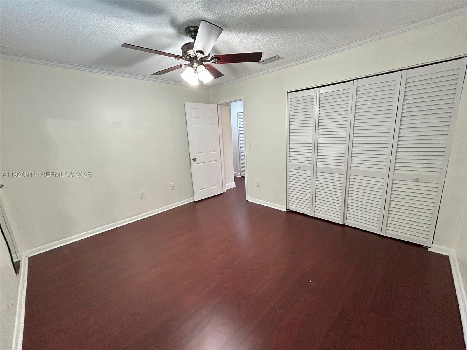 13444 Southwest 62nd Street, Unit 104F Miami, FL 33183 - Photo 31 of 40 an empty room with a ceiling fan and a window