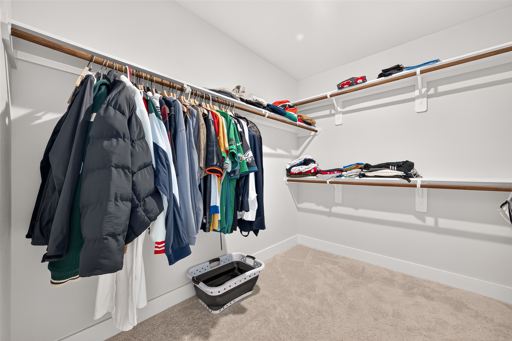 4004 Baja Lane Houston, TX 77045 - Photo 22 of 34 Generous proportions meet ultimate utility. Step into this beautifully maximized walk-in closet, offering ample room for all your wardrobe essentials. The thoughtful layout combines multi-level hanging sections with sturdy shelving, ensuring a clean, bright, and easily accessible space.
