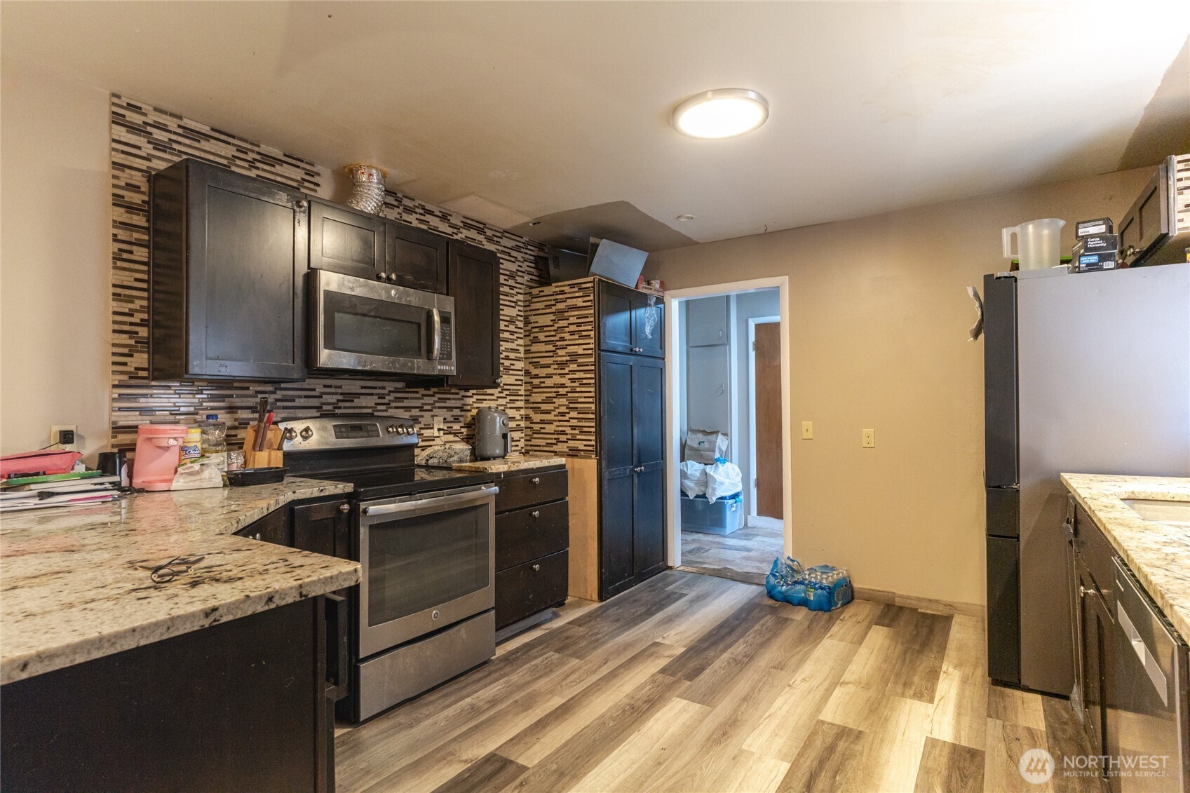 218 3rd Avenue Southwest Quincy, WA 98848 - Photo 9 of 20 a kitchen with stainless steel appliances granite countertop a sink stove and refrigerator