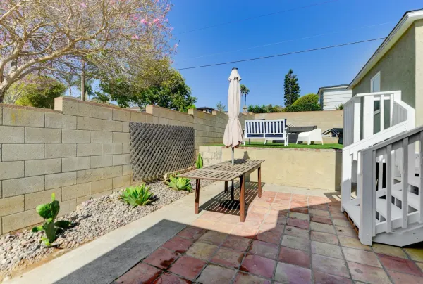 a view of a patio with couches table and chairs and potted plants