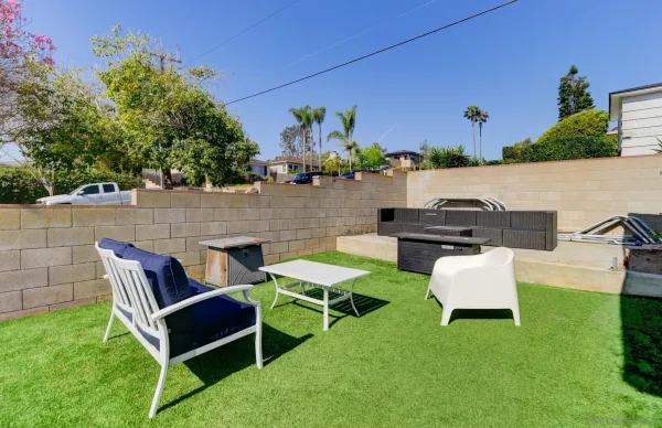 an outdoor sitting area with couch and a potted plant