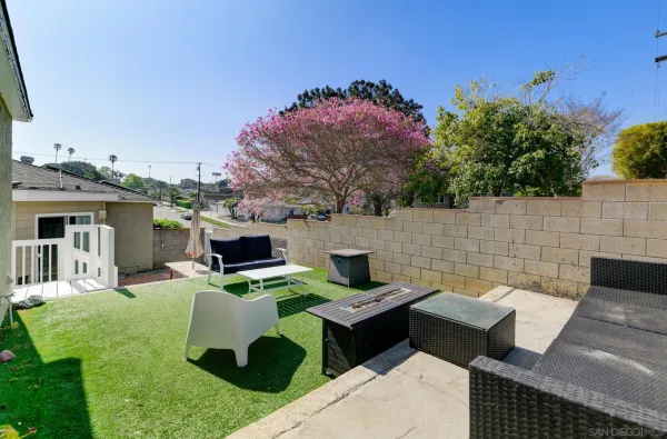a view of a backyard with furniture and a fireplace