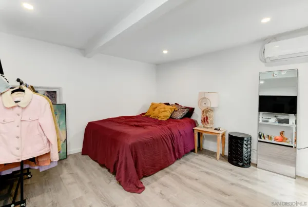 a bedroom with a bed and a television