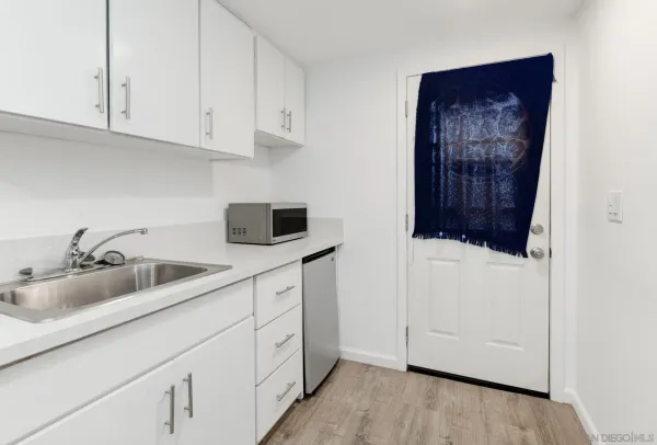 a kitchen with white cabinets and a sink