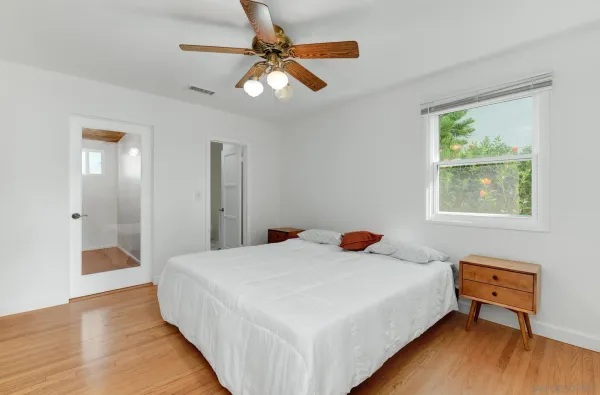 a bedroom with a bed and a chandelier