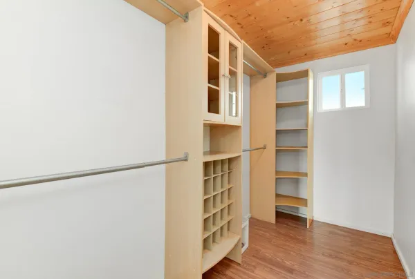 a view of walk in closet with empty racks