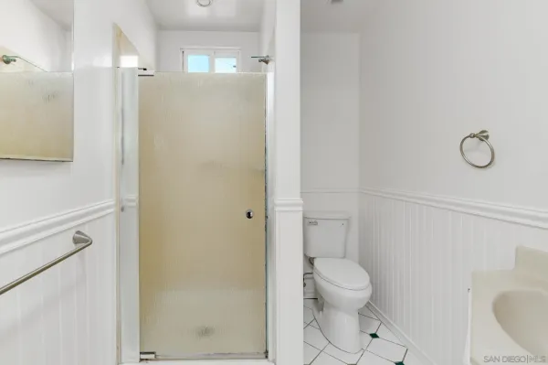 a bathroom with a toilet and a shower