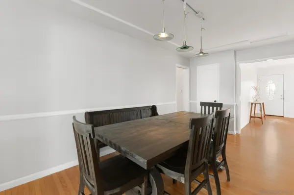 a view of a dining room with furniture and wooden floor