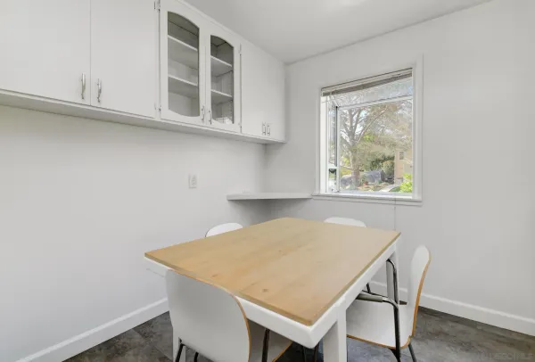 a view of a dining room that has a table and a window