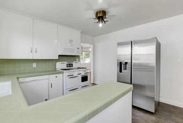 a kitchen with cabinets and stainless steel appliances