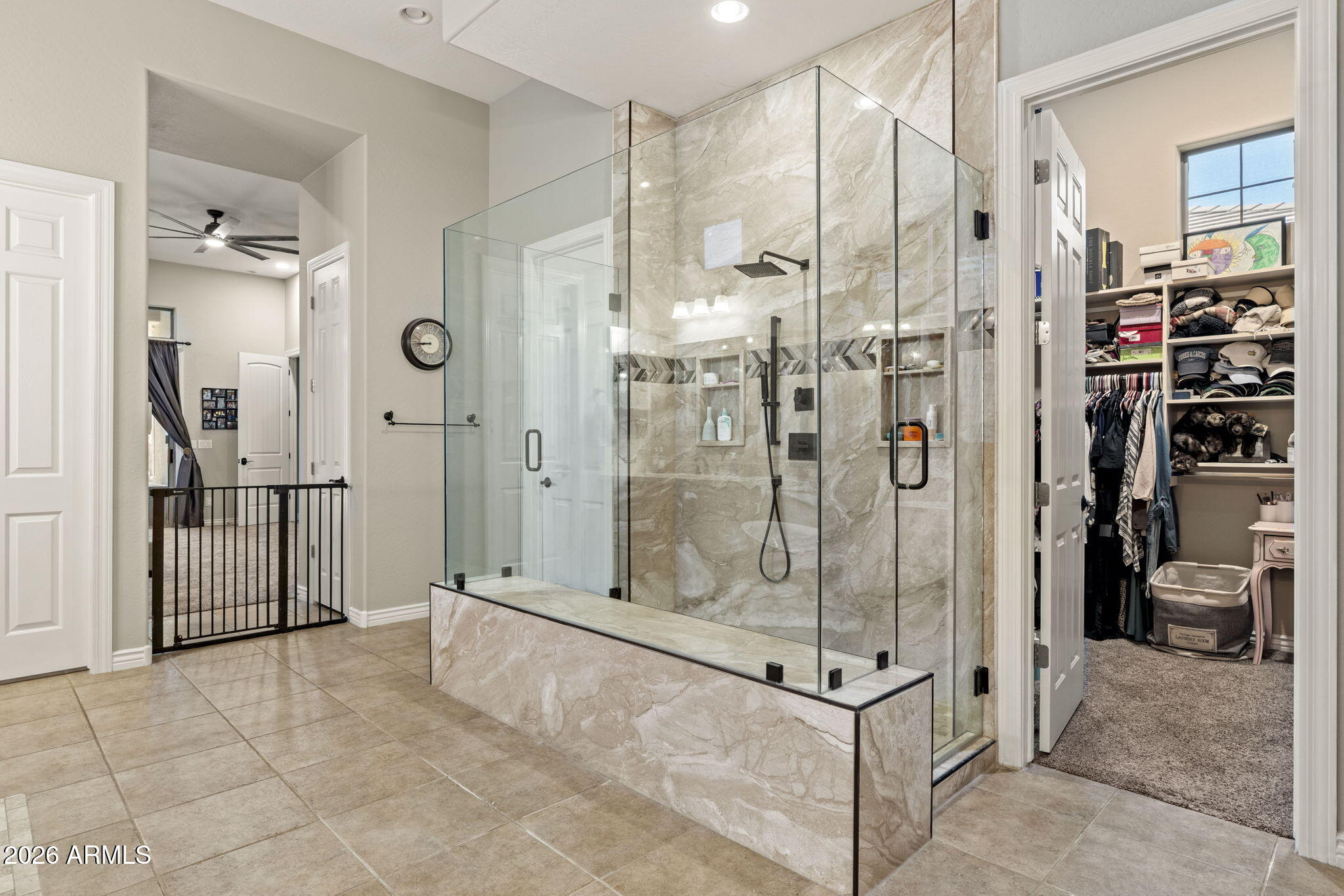 41619 North River Bend Road Anthem, AZ 85086 - Photo 12 of 84 a bathroom with a glass shower door and a glass door