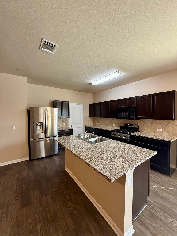 1701 Atlas Road Cedar Park, TX 78613 - Photo 2 of 23 a kitchen with stainless steel appliances granite countertop a stove a sink and a refrigerator