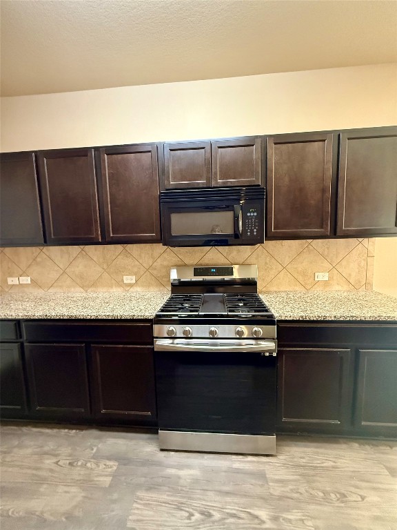 1701 Atlas Road Cedar Park, TX 78613 - Photo 3 of 23 a kitchen with a stove and a cabinet