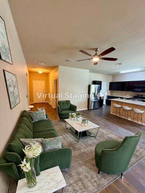 1701 Atlas Road Cedar Park, TX 78613 - Photo 7 of 23 a living room with furniture and a wooden floor