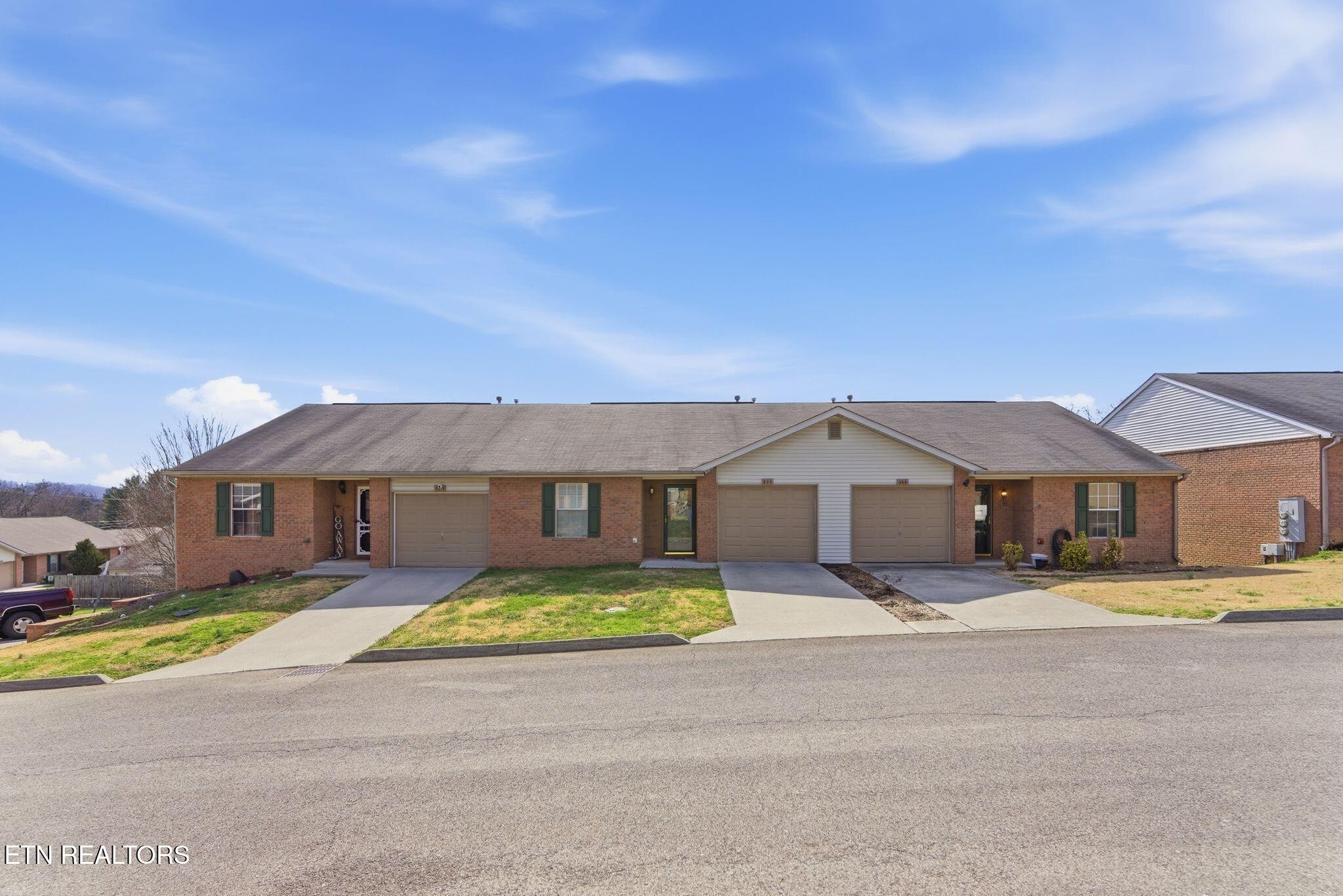 355 Hawthorne Oaks Way Powell, TN 37849 - Photo 1 of 31 a front view of a house with a garden and yard