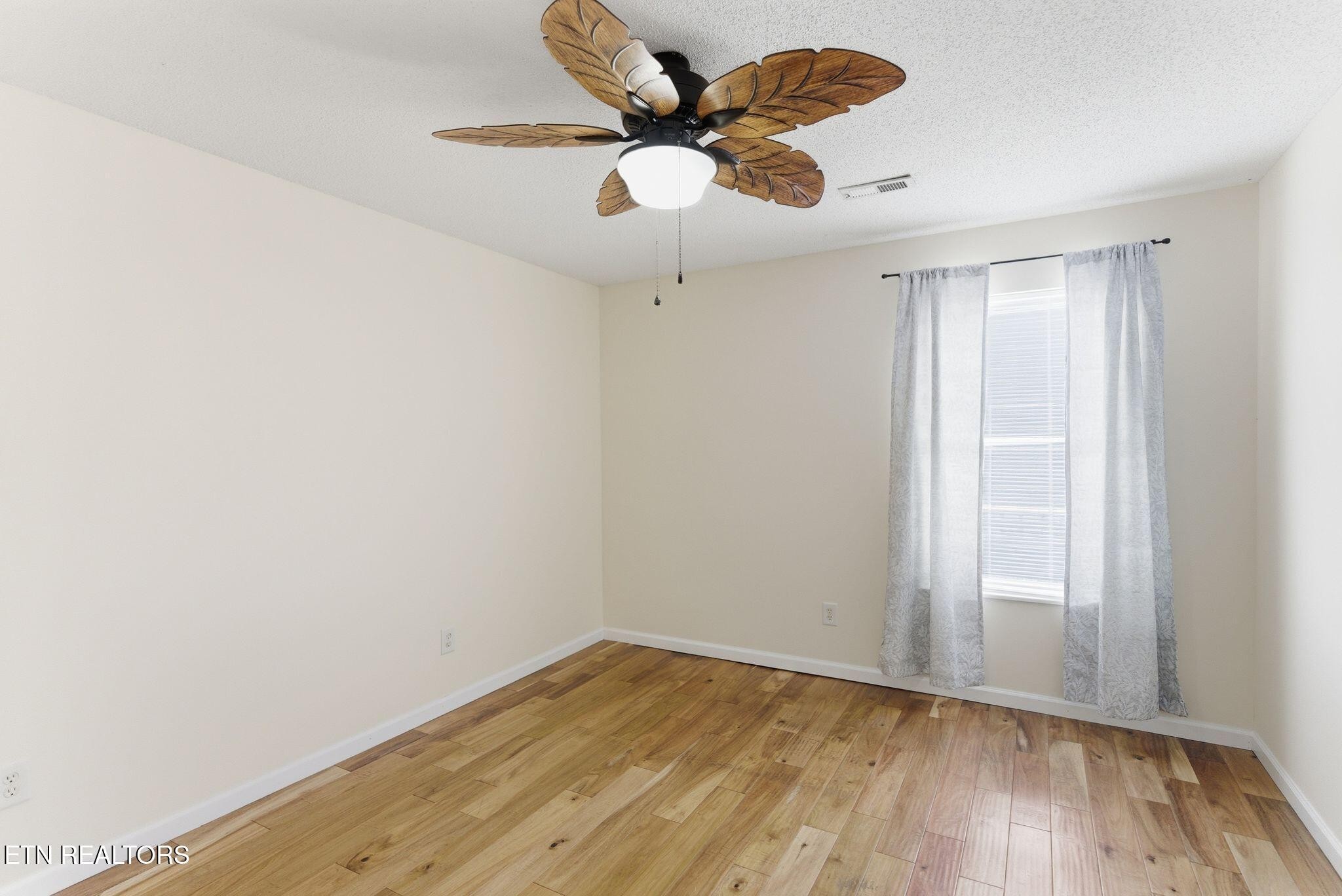 355 Hawthorne Oaks Way Powell, TN 37849 - Photo 16 of 31 a view of an empty room and wooden floor