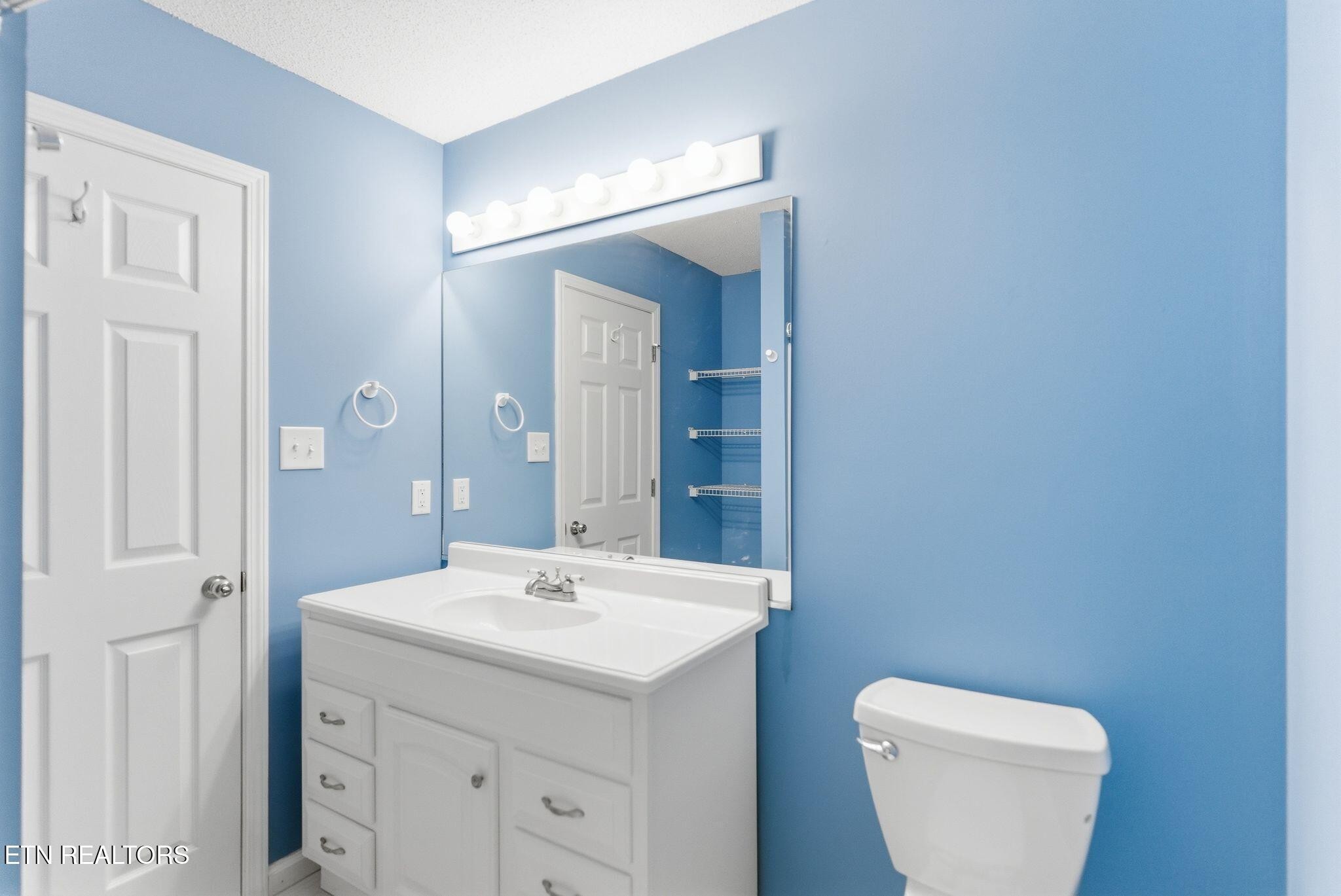 355 Hawthorne Oaks Way Powell, TN 37849 - Photo 18 of 31 a bathroom with a toilet sink and mirror