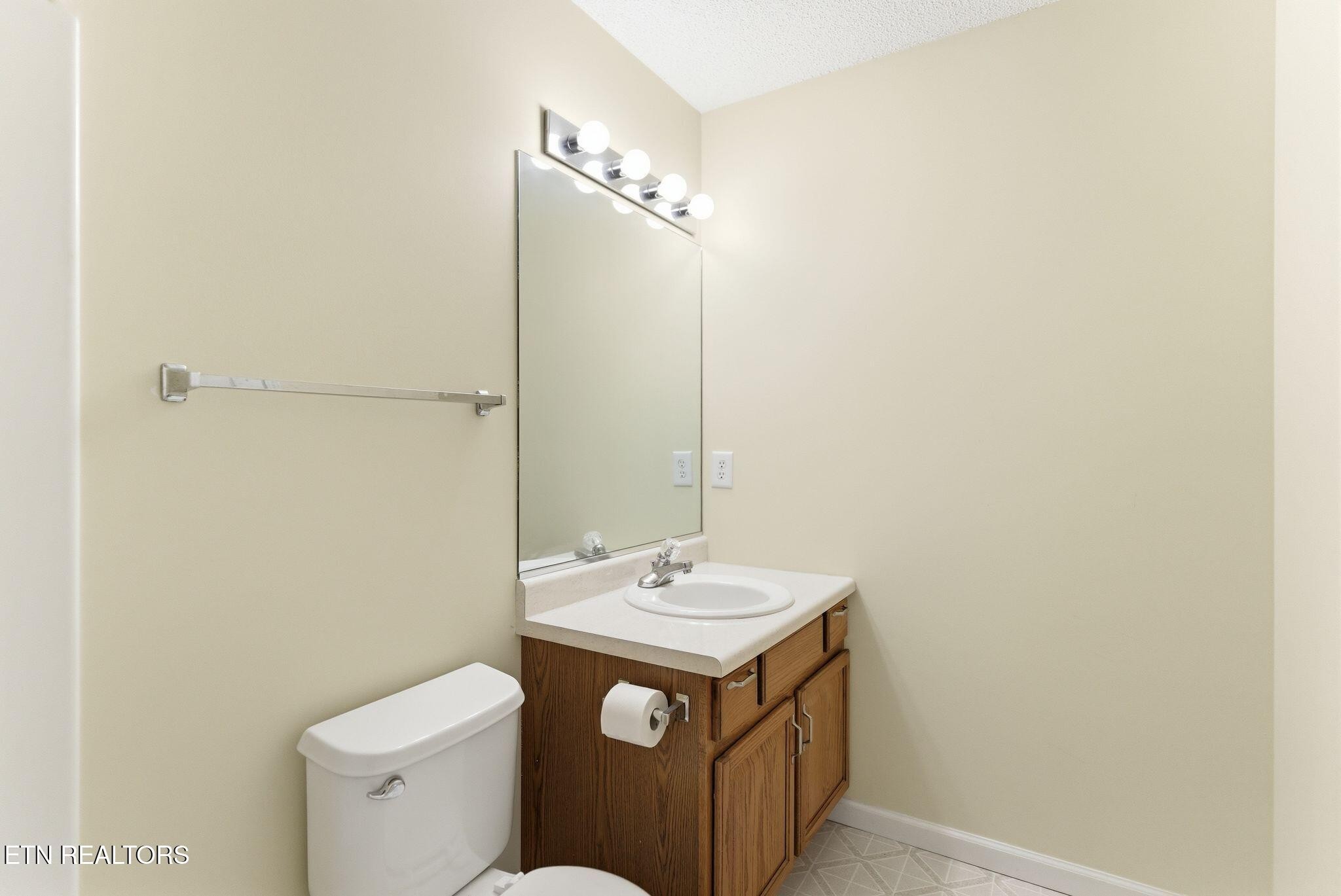355 Hawthorne Oaks Way Powell, TN 37849 - Photo 23 of 31 a bathroom with a sink a toilet and a mirror
