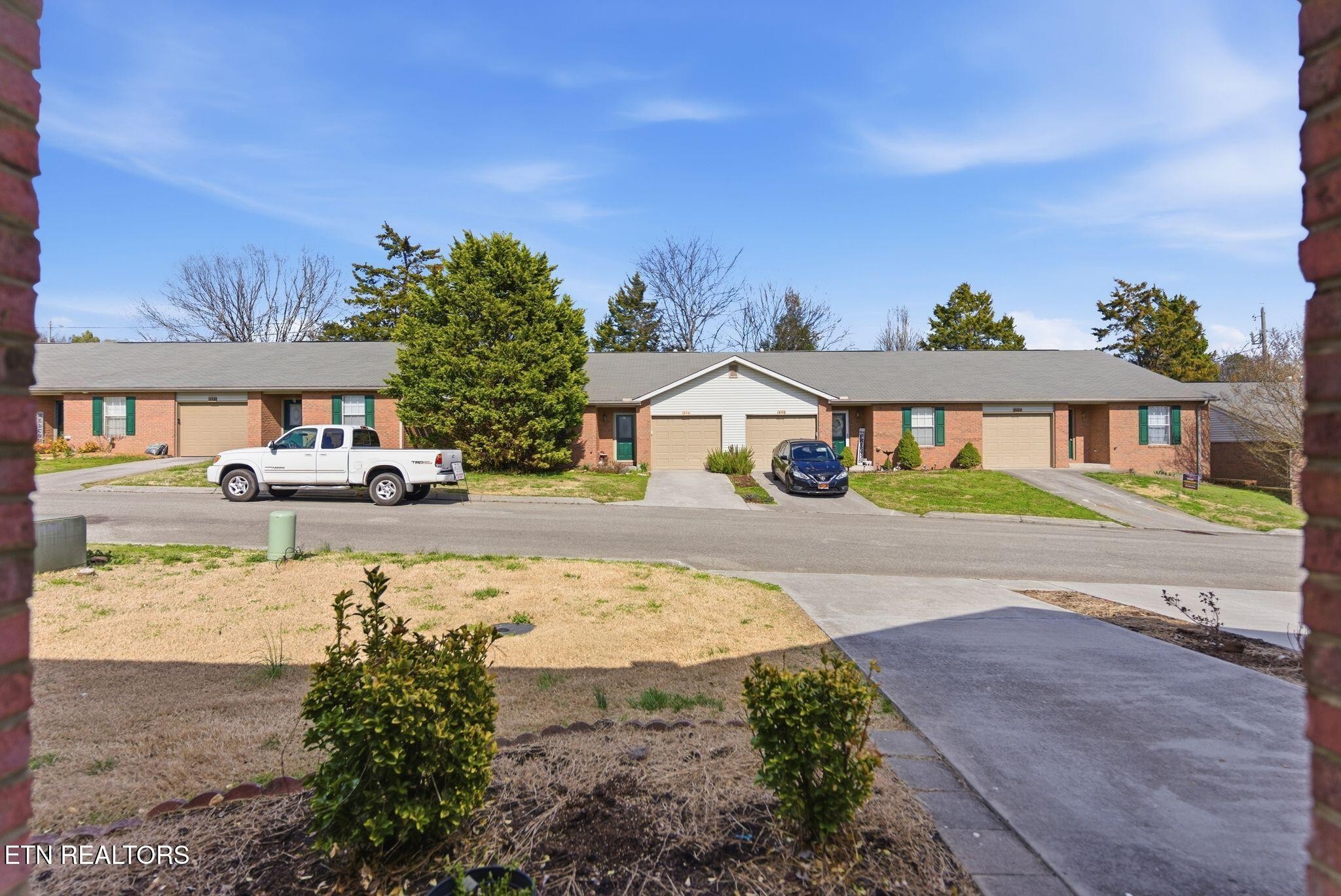 355 Hawthorne Oaks Way Powell, TN 37849 - Photo 4 of 31 a front view of a house with a yard