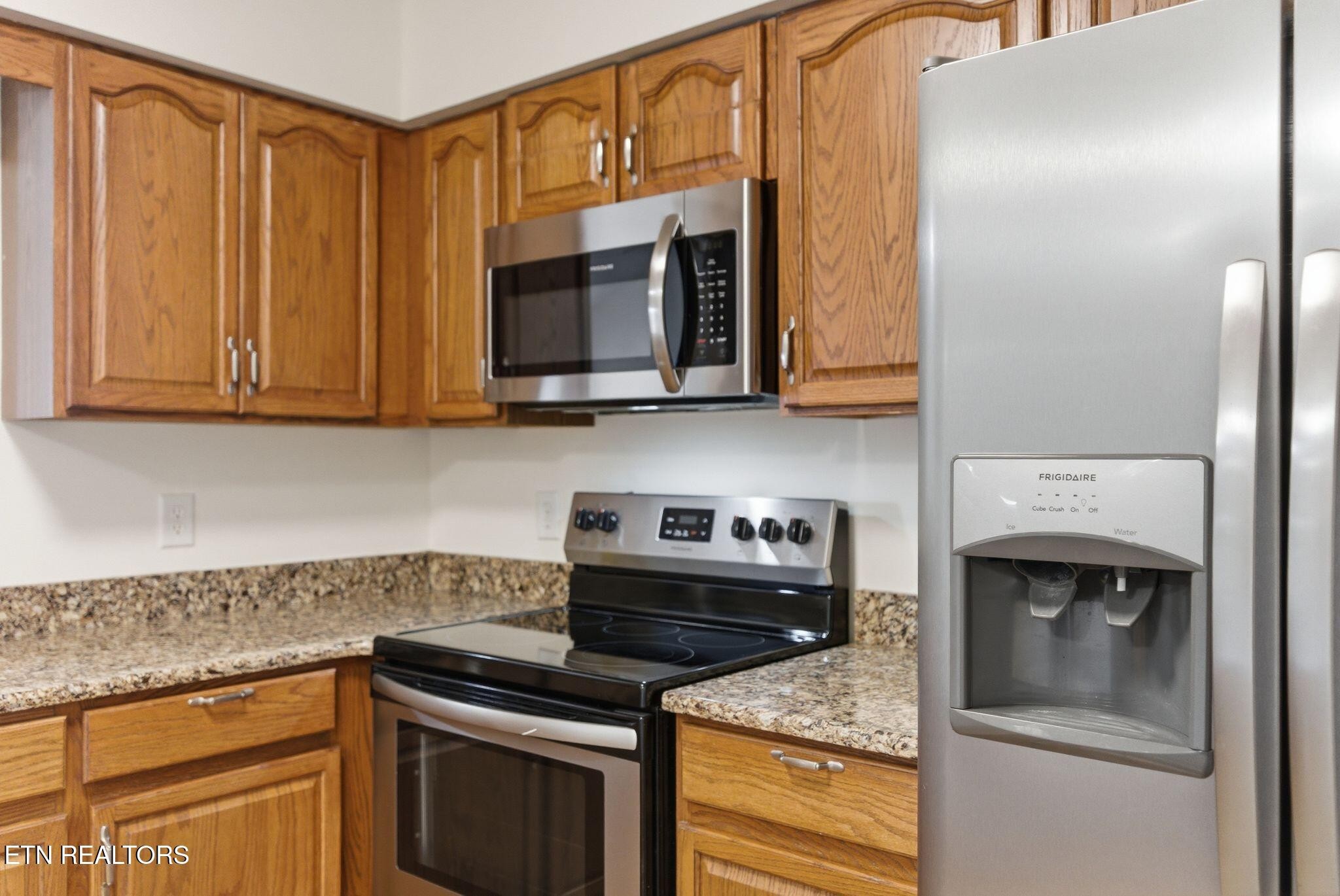 355 Hawthorne Oaks Way Powell, TN 37849 - Photo 10 of 31 a kitchen with stainless steel appliances granite countertop a stove microwave and cabinets