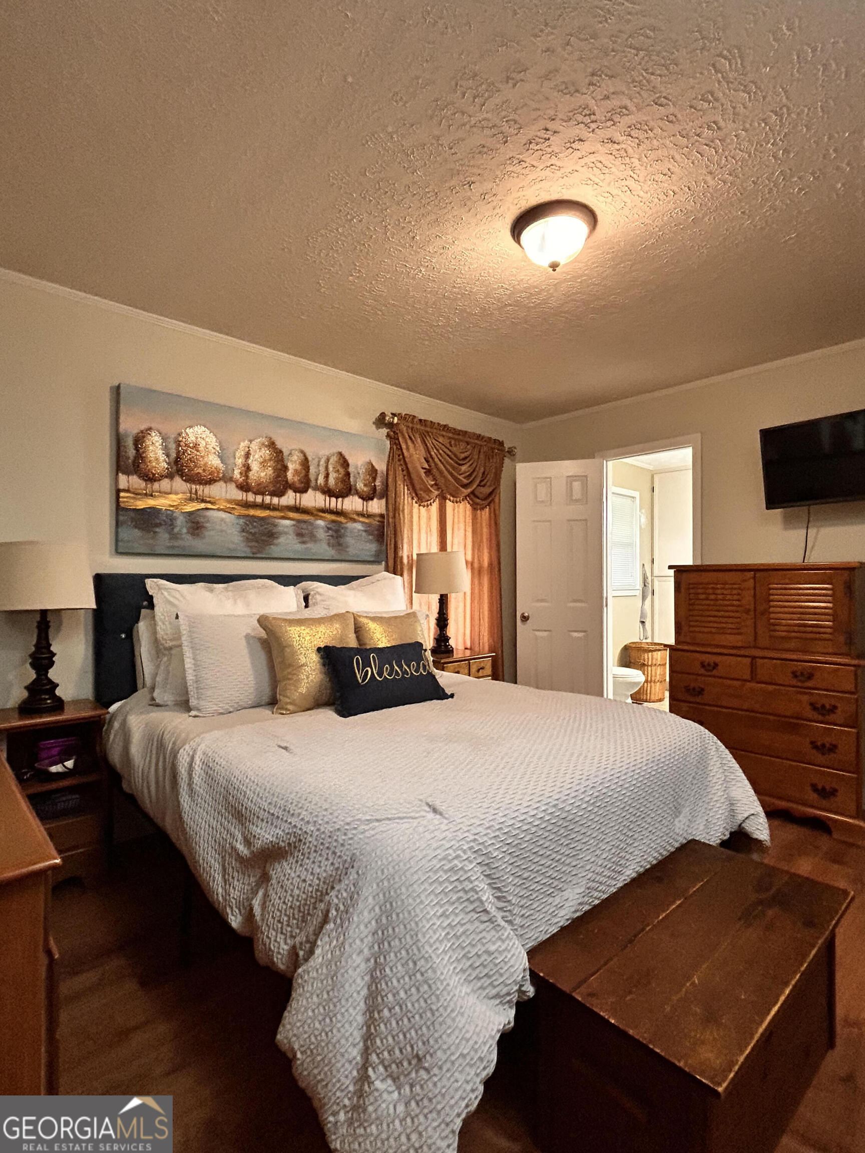 711 West Ridgeway Road Maysville, GA 30558 - Photo 17 of 38 a bedroom with a bed and a night stand