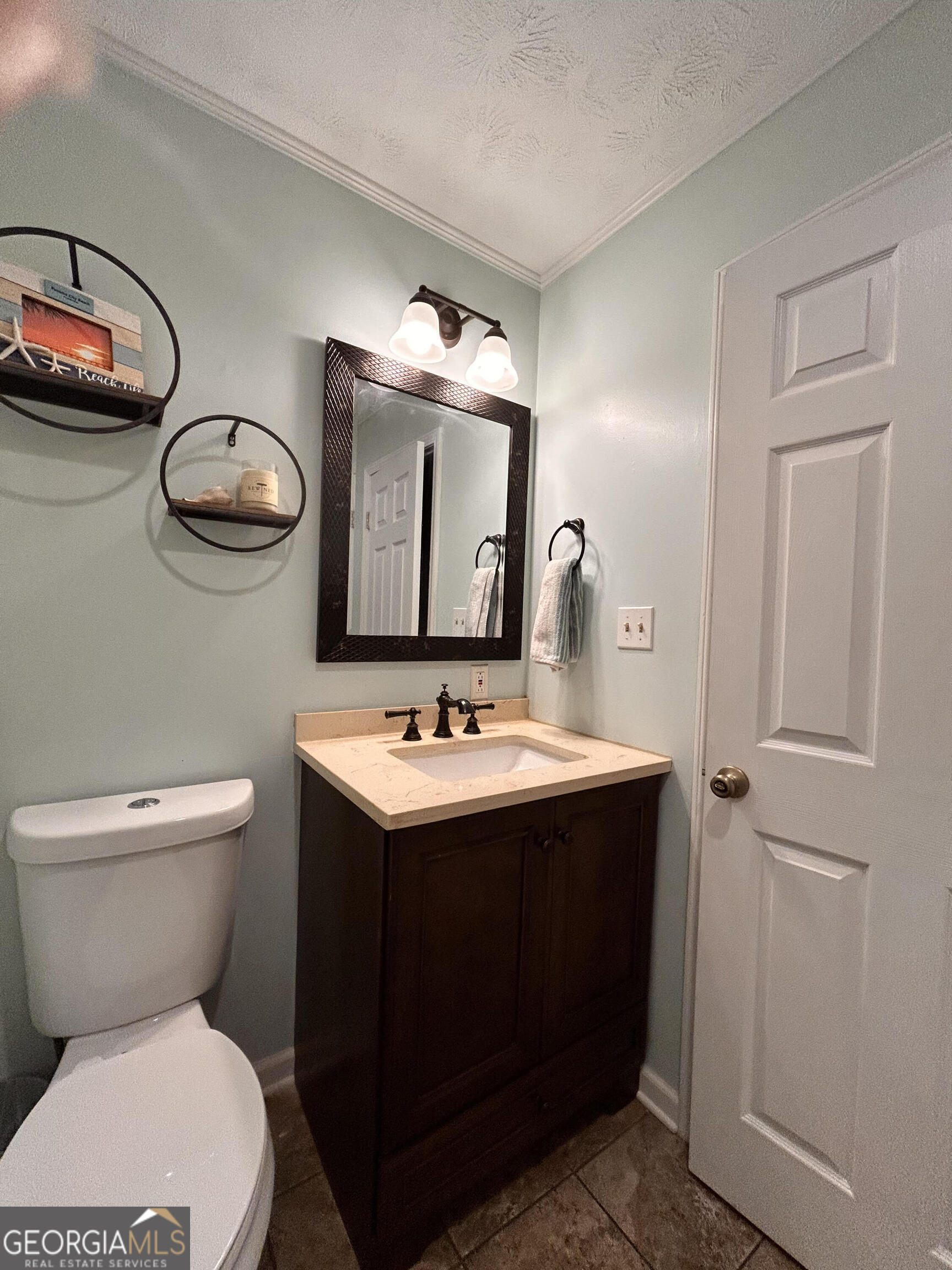 711 West Ridgeway Road Maysville, GA 30558 - Photo 19 of 38 a bathroom with a toilet sink and mirror