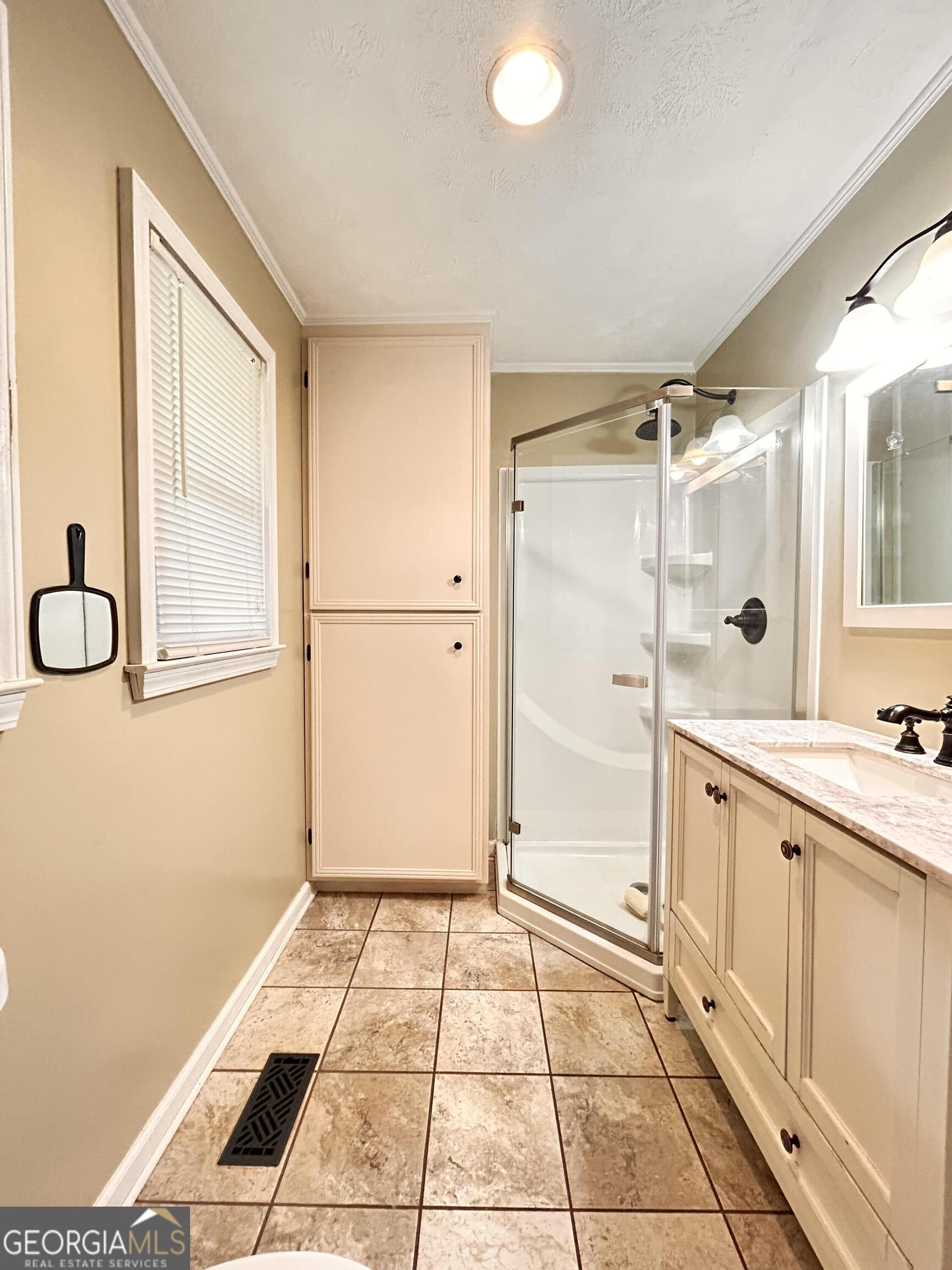 711 West Ridgeway Road Maysville, GA 30558 - Photo 22 of 38 a bathroom with a granite countertop sink a mirror and a shower