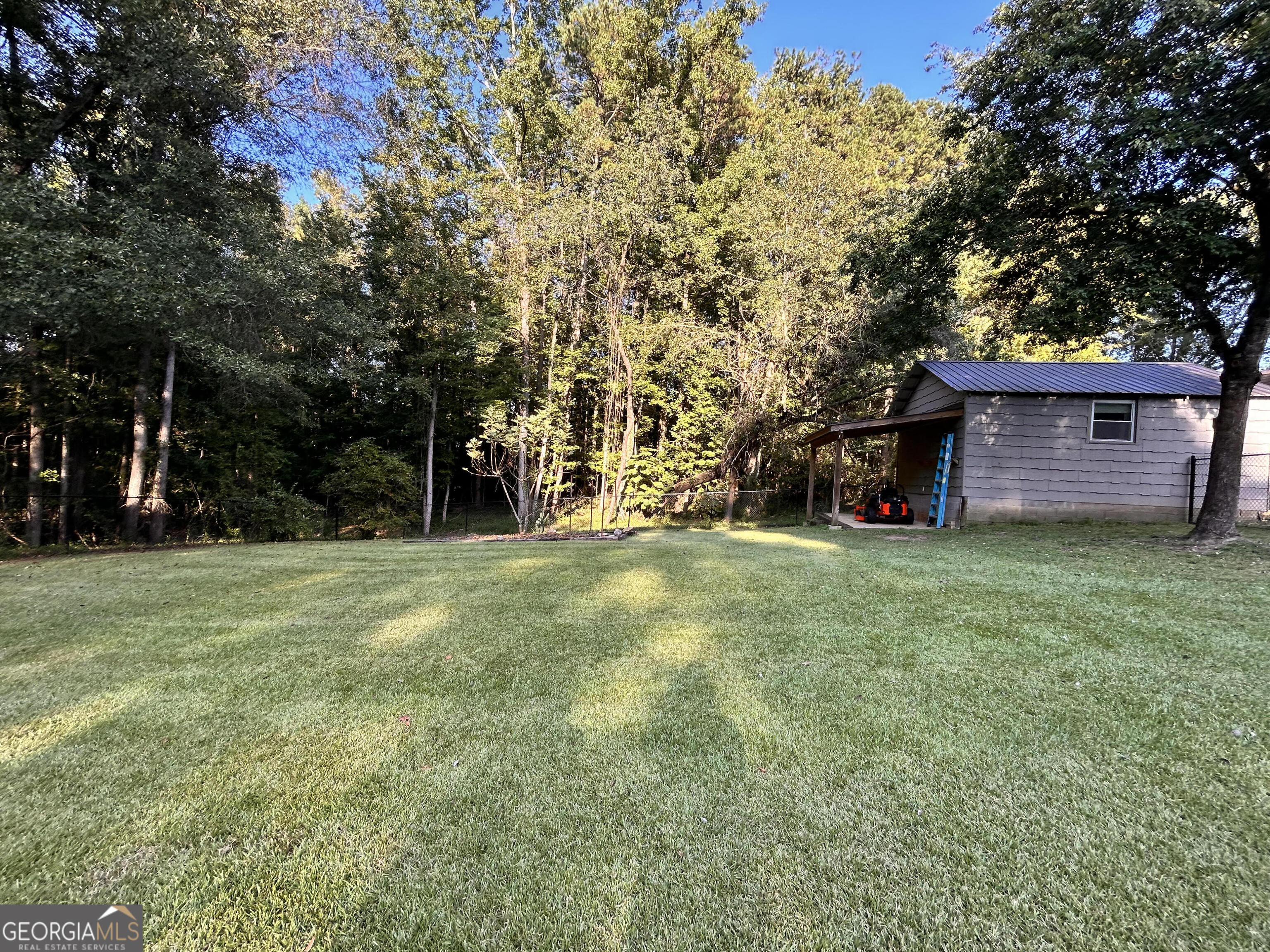 711 West Ridgeway Road Maysville, GA 30558 - Photo 34 of 38 a view of a backyard with a garden