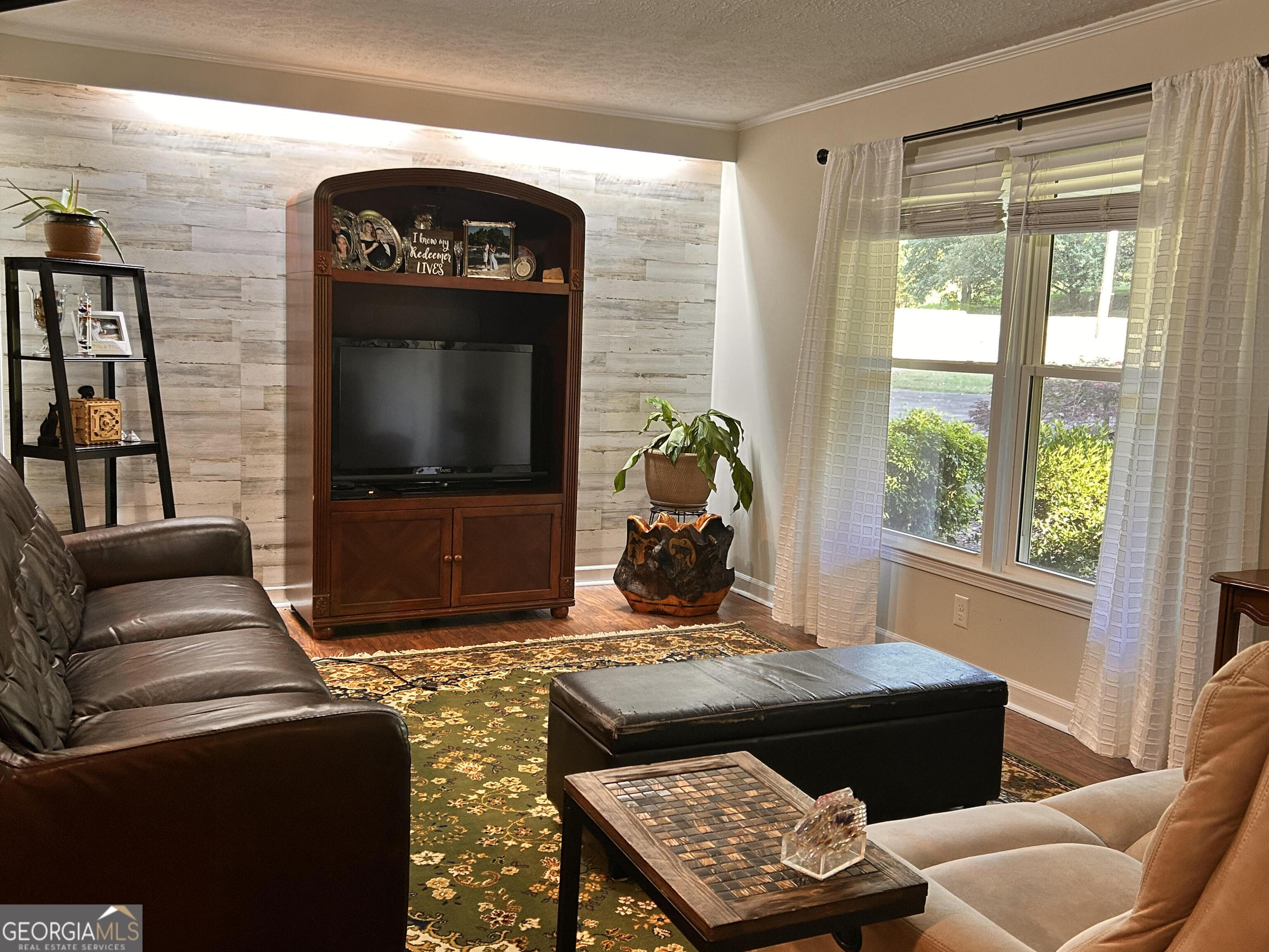 711 West Ridgeway Road Maysville, GA 30558 - Photo 5 of 38 a living room with furniture a flat screen tv and a window