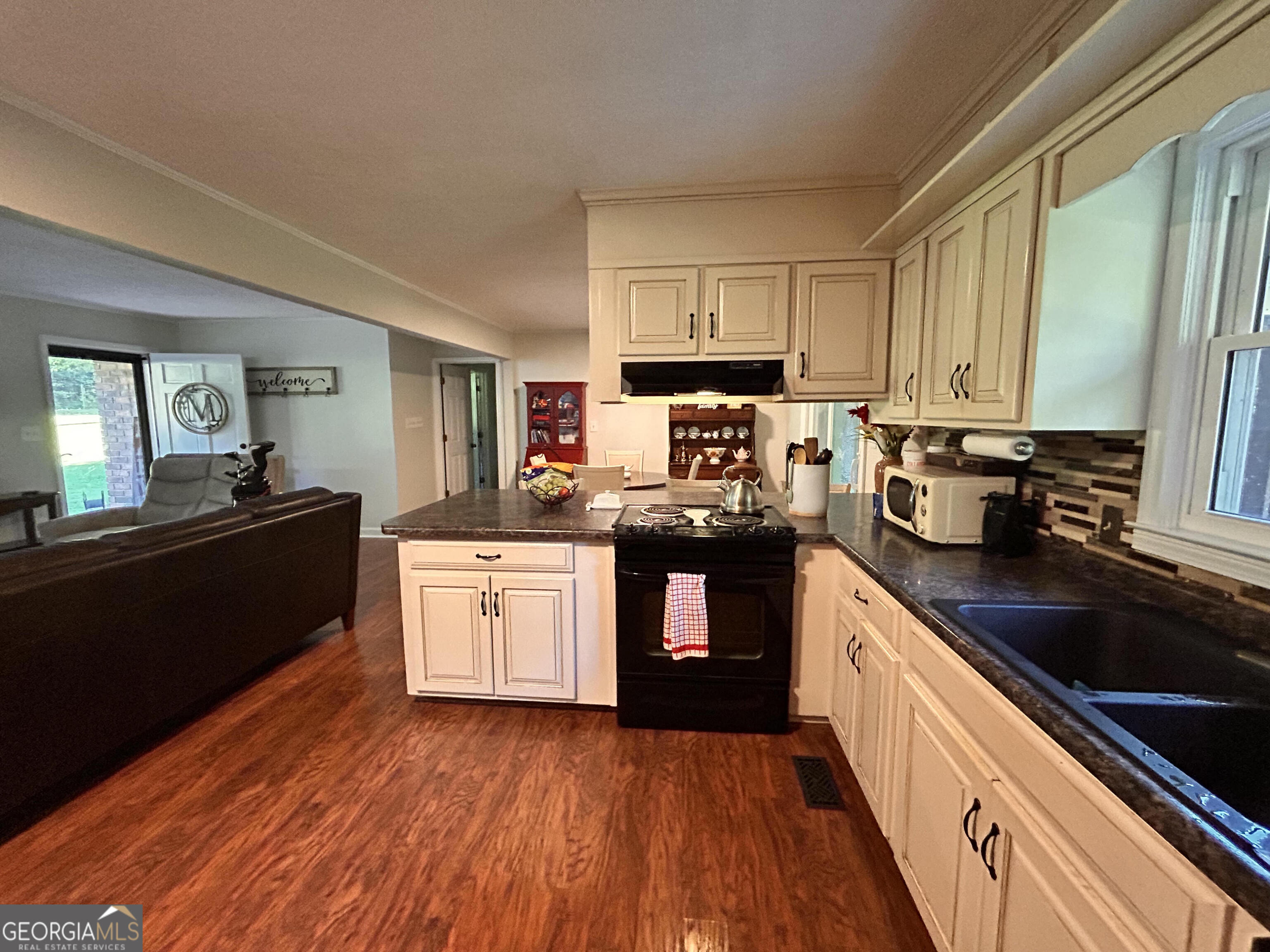 711 West Ridgeway Road Maysville, GA 30558 - Photo 8 of 38 a kitchen with stainless steel appliances granite countertop a sink cabinets and wooden floor