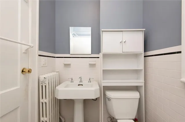 a bathroom with a sink a toilet and vanity