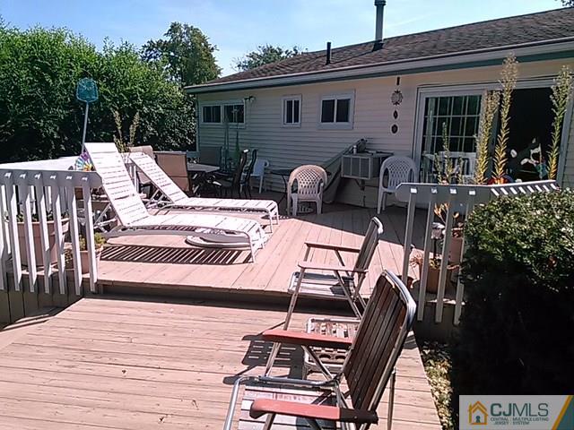 21 Georgetown Road Old Bridge, NJ 08859 - Photo 14 of 17 a view of a patio with table and chairs with wooden floor and fence