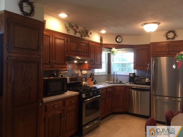 21 Georgetown Road Old Bridge, NJ 08859 - Photo 6 of 17 a kitchen with a sink stainless steel appliances and cabinets