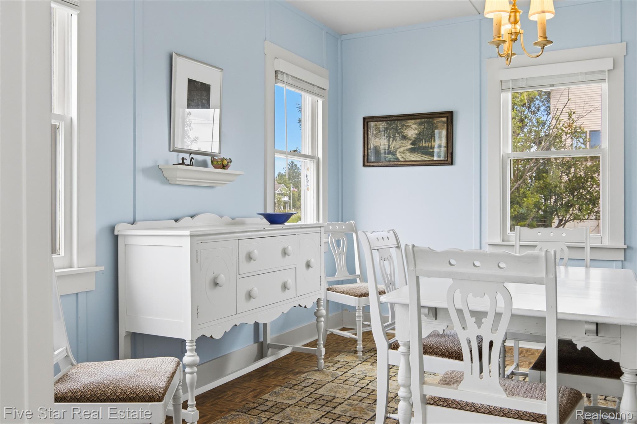 2588 Lakeview Road Onekama, MI 49675 - Photo 17 of 32 Dining area with light blue walls and wood-finish flooring