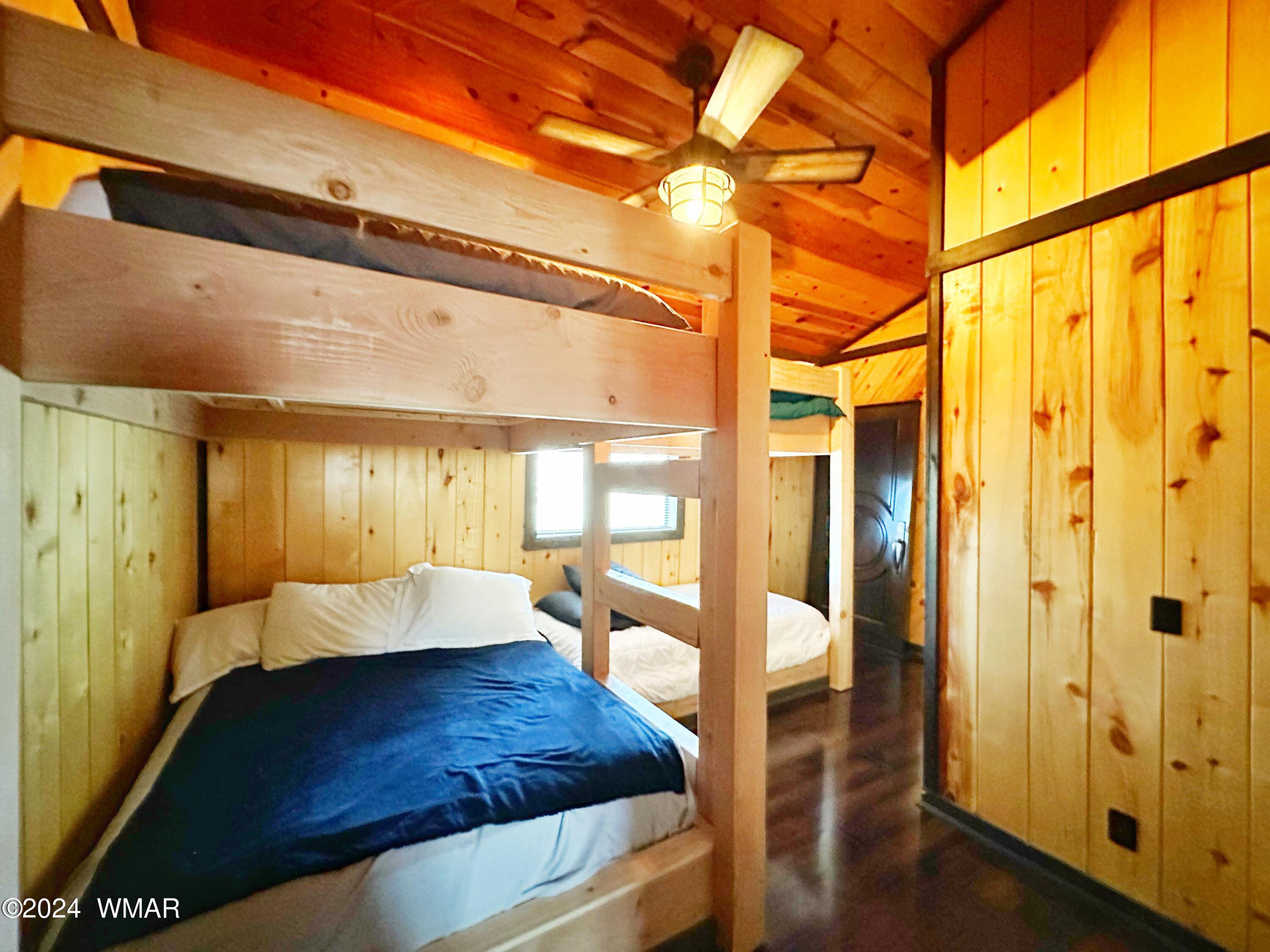 3403 Top View Road Overgaard, AZ 85933 - Photo 12 of 19 a bedroom with a bed and wooden floor