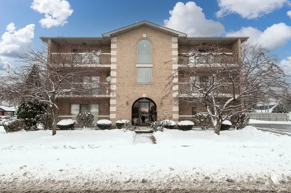 a view of a fireplace with a snow in front of house
